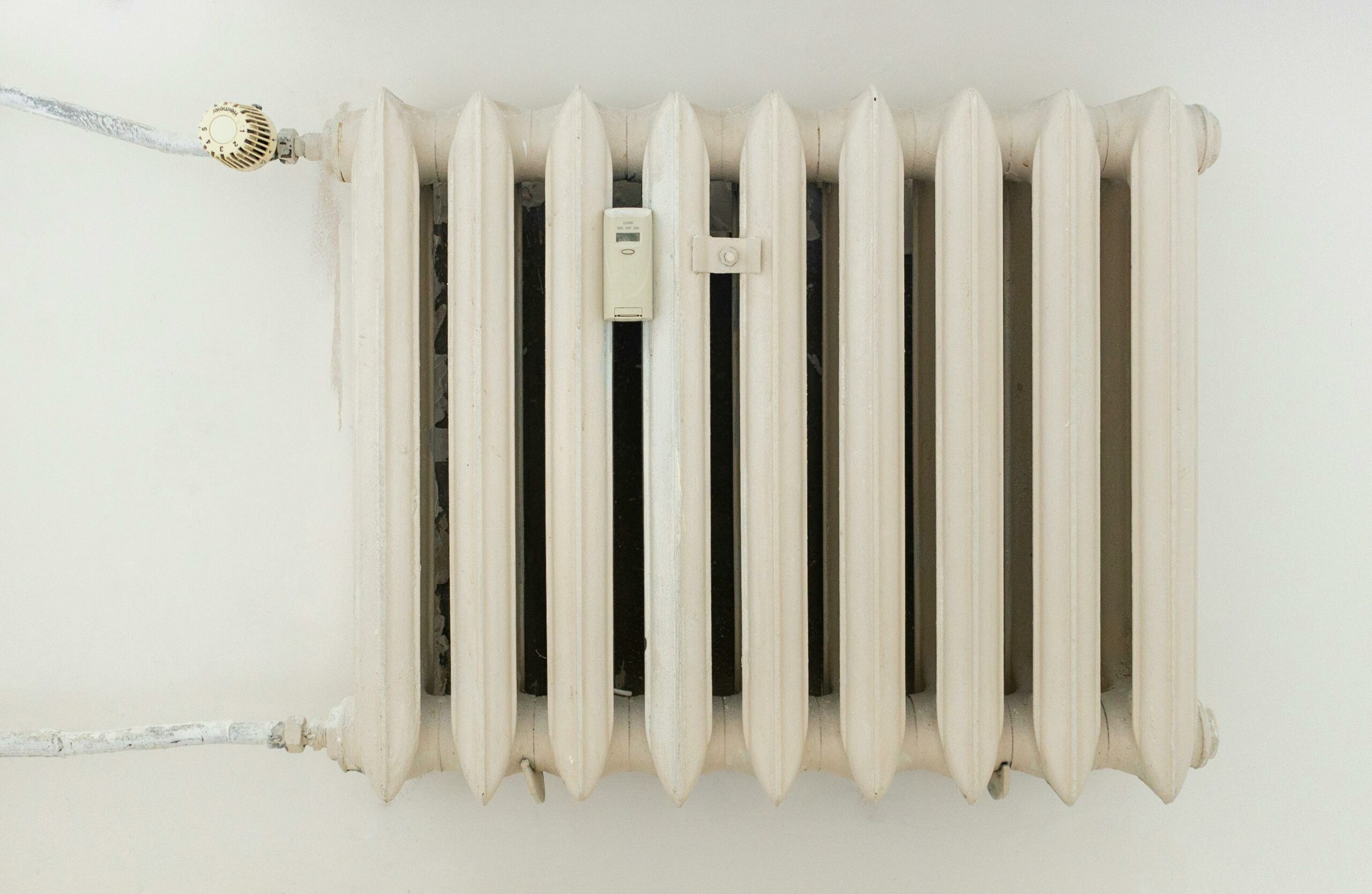 White steel rib radiator in a new bright renovated room in apartment or home